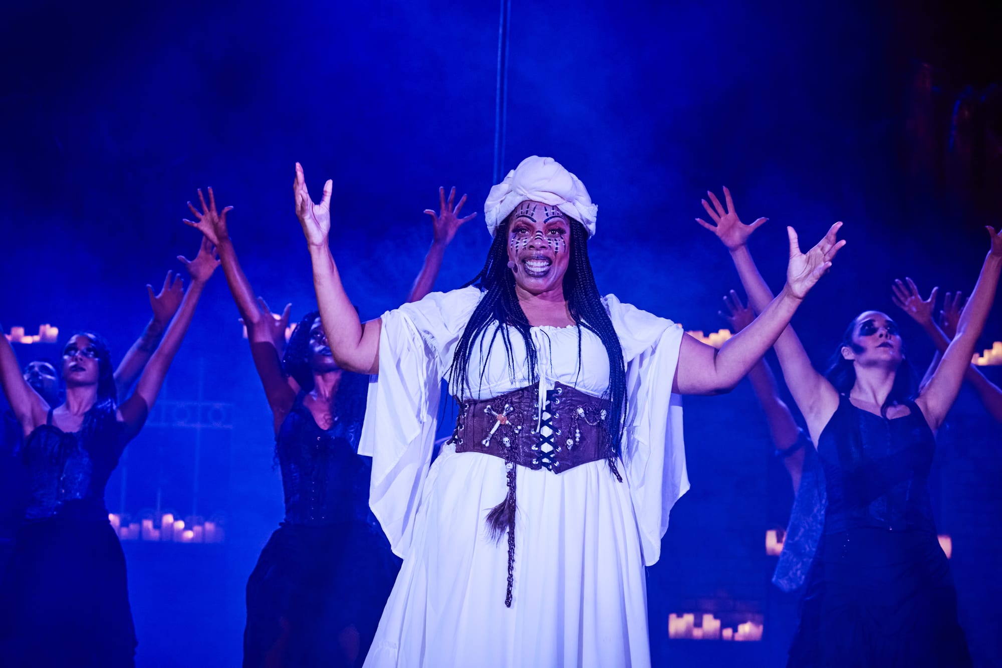Regina Levert as Marie Laveau raises her arms as the Gede rise behind her — Voodoo: Bayou's Edge, Knott's Scary Farm 2026